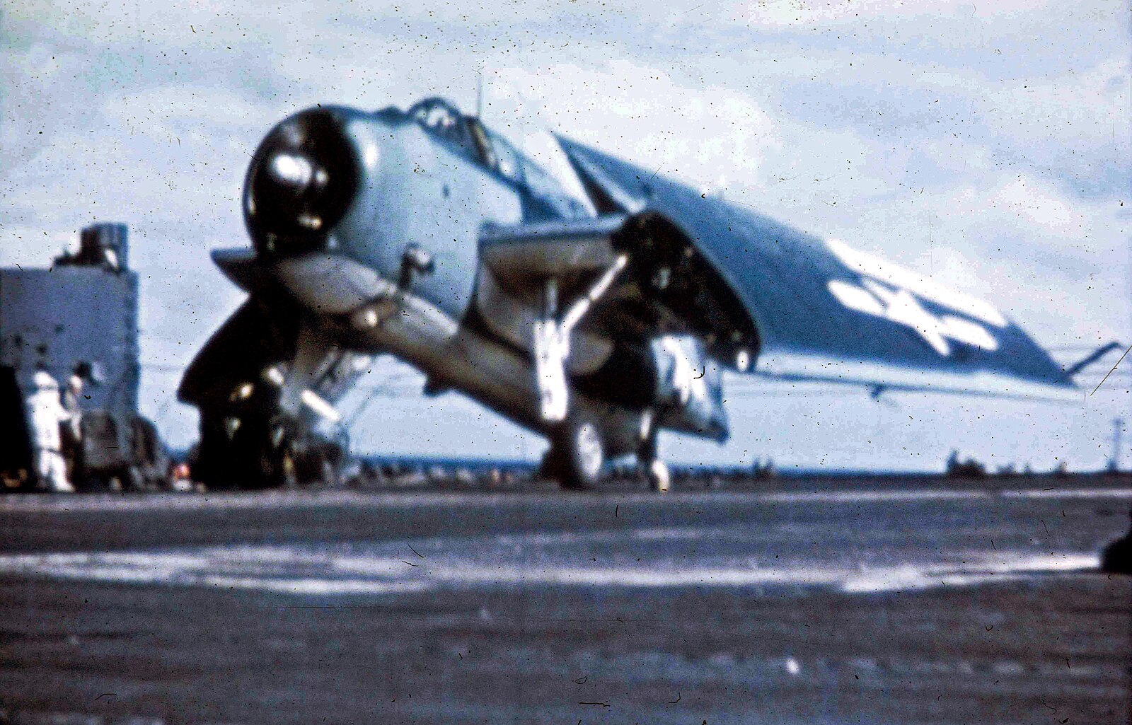 A U.S. Navy Grumman TBM  Avenger  folding its wings after landing aboard an aircraft carrier in the Pacific, 1945. The geometric identificat