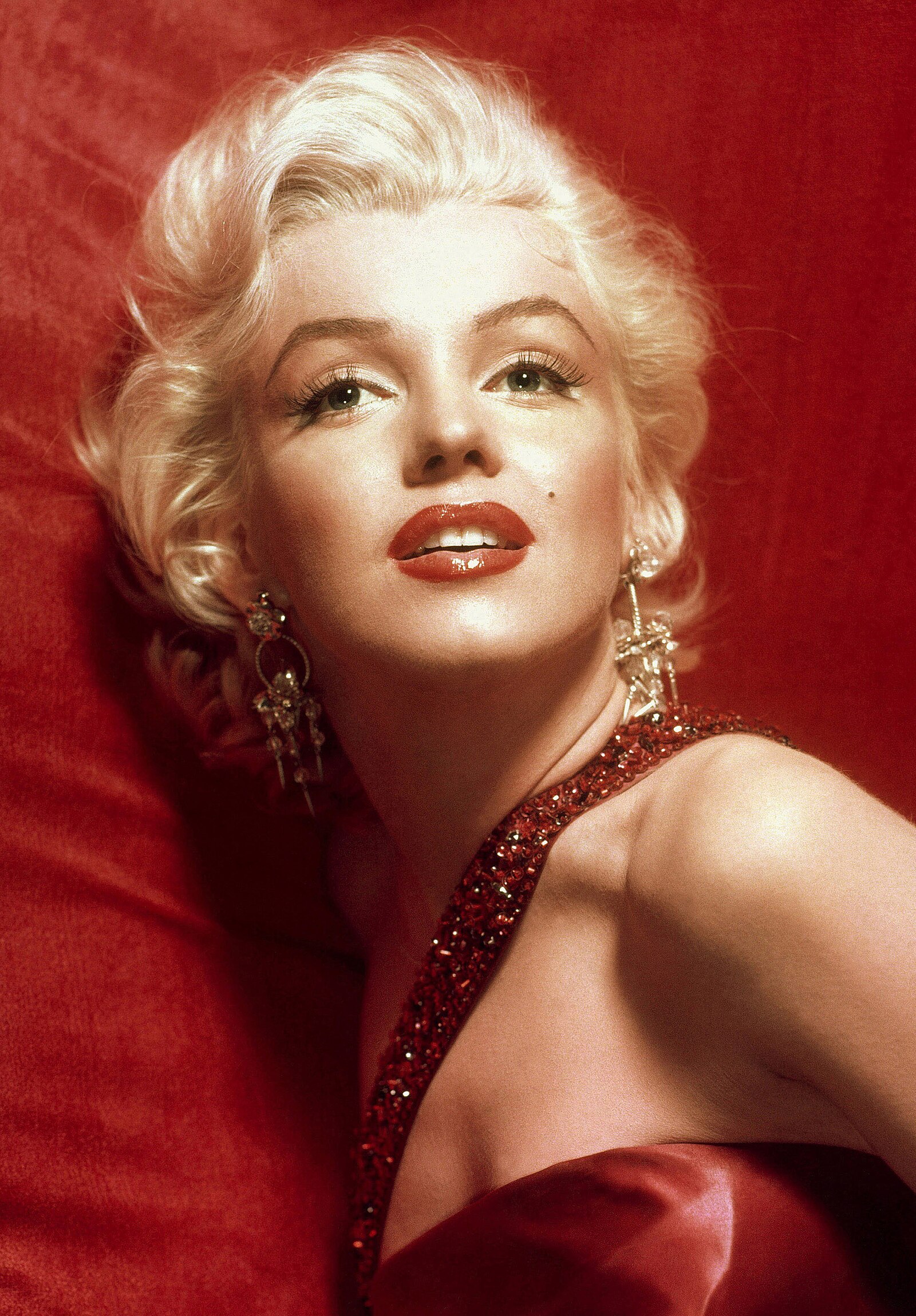 A glamorous Marilyn Monroe in a red dress, taken for publicity purposes for 1953 film  How to Marry a Millionaire .