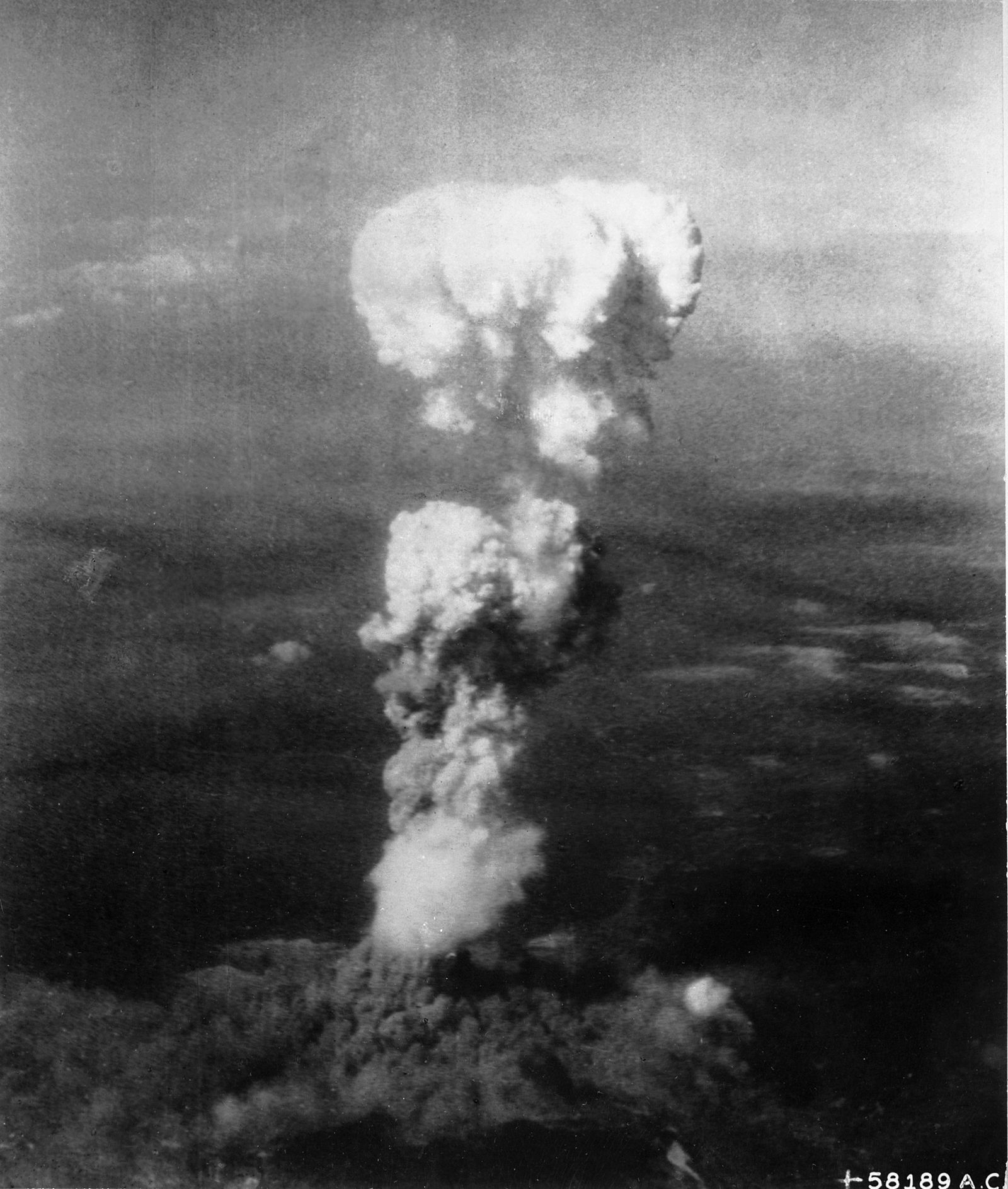 At the time this photo was made, smoke billowed 20,000 feet above Hiroshima while smoke from the burst of the first atomic bomb had spread o