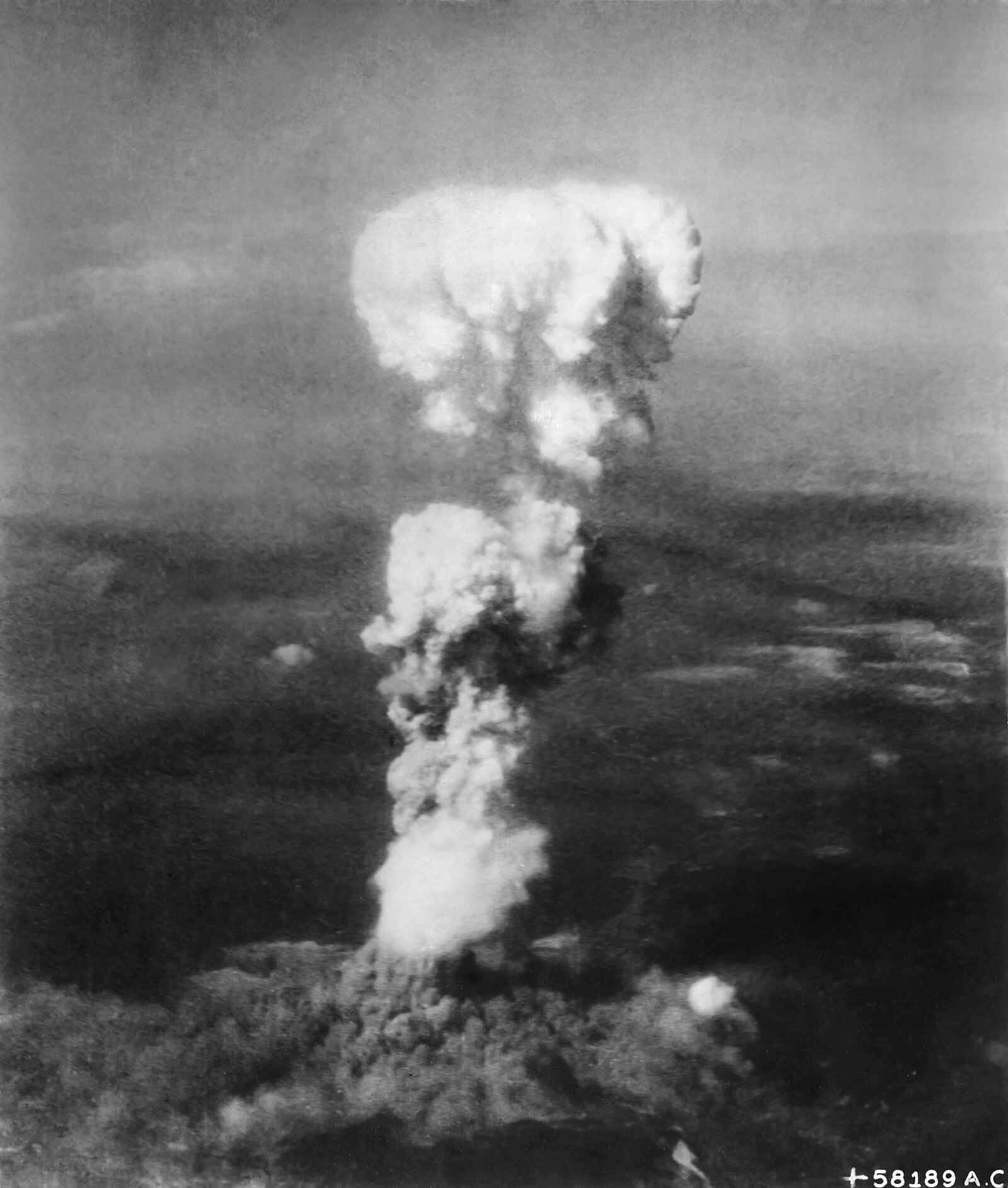 At the time this photo was made, smoke billowed 20,000 feet above Hiroshima while smoke from the burst of the first atomic bomb had spread o