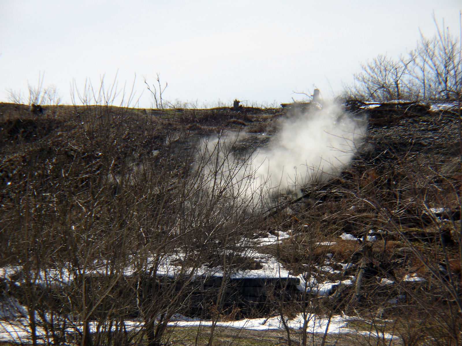 A plume of smoke wafts from the ground in Centralia, Pennsylvania, site of an underground coal seam fire.