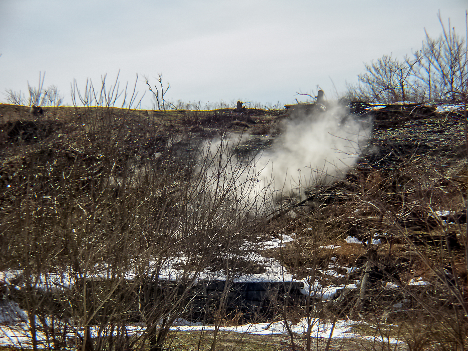 A plume of smoke wafts from the ground in Centralia, Pennsylvania, site of an underground coal seam fire.